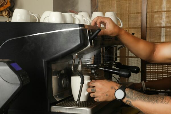 Close-up of barista making coffee in Bengaluru, India. Modern espresso machine in use.